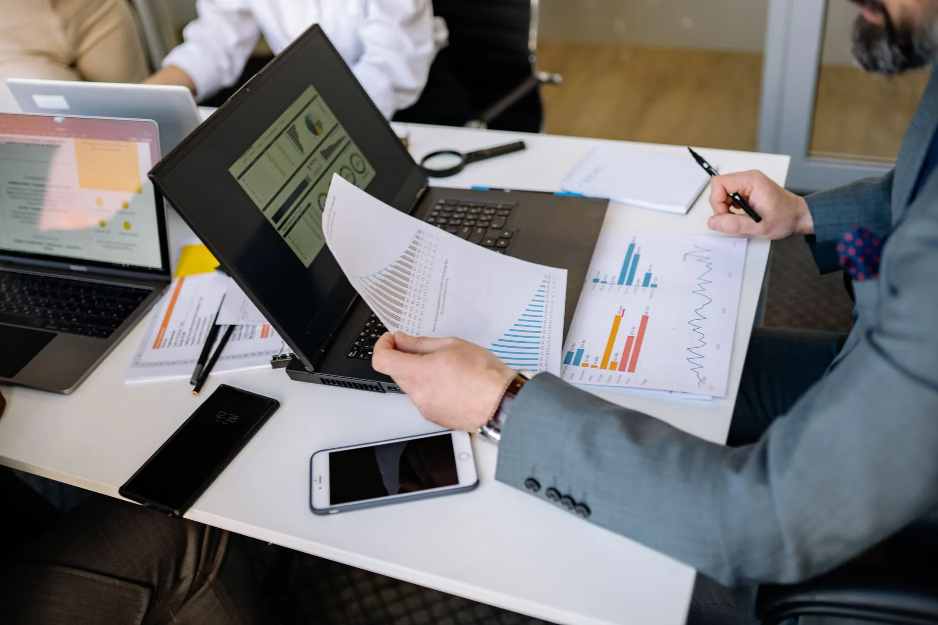 Business energy finance review with charts and documents